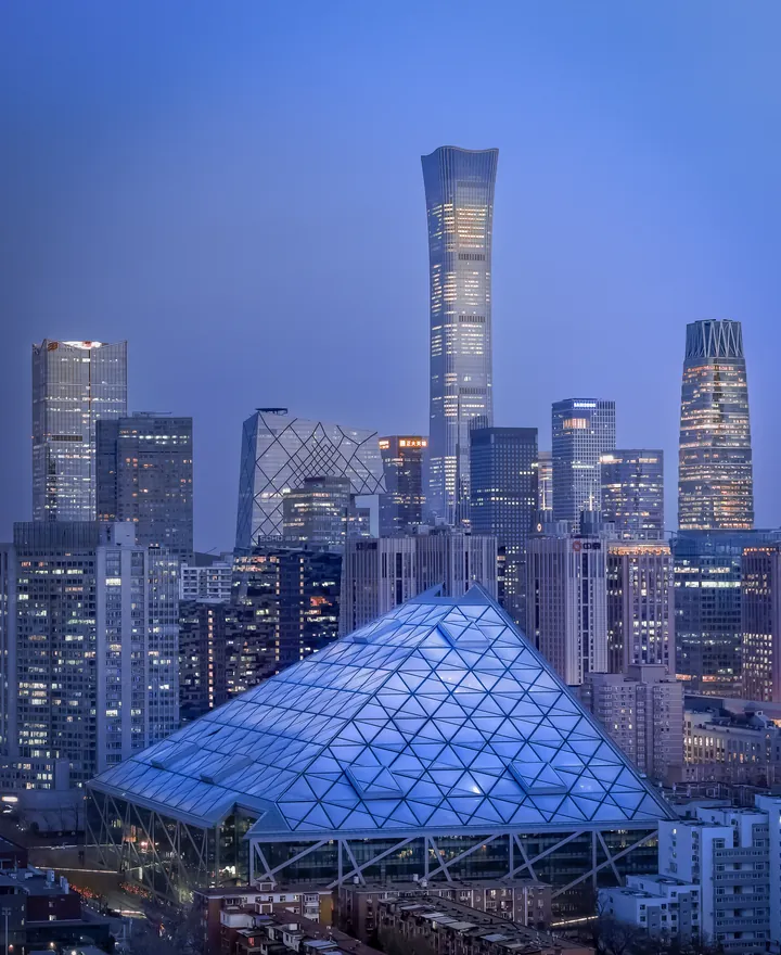 A city skyline and glass architecture at blue hour