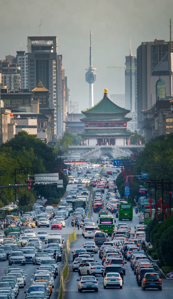 Traffic on a busy city street lined with buildings
