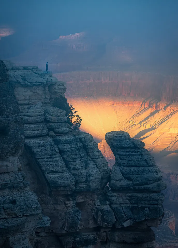 Warm light falling between layered rock formations